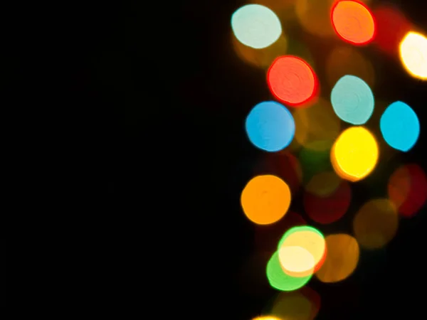 Bokeh luz com um fundo preto . — Fotografia de Stock