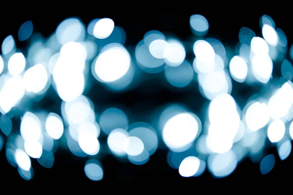 Luce bokeh con uno sfondo nero . — Foto Stock