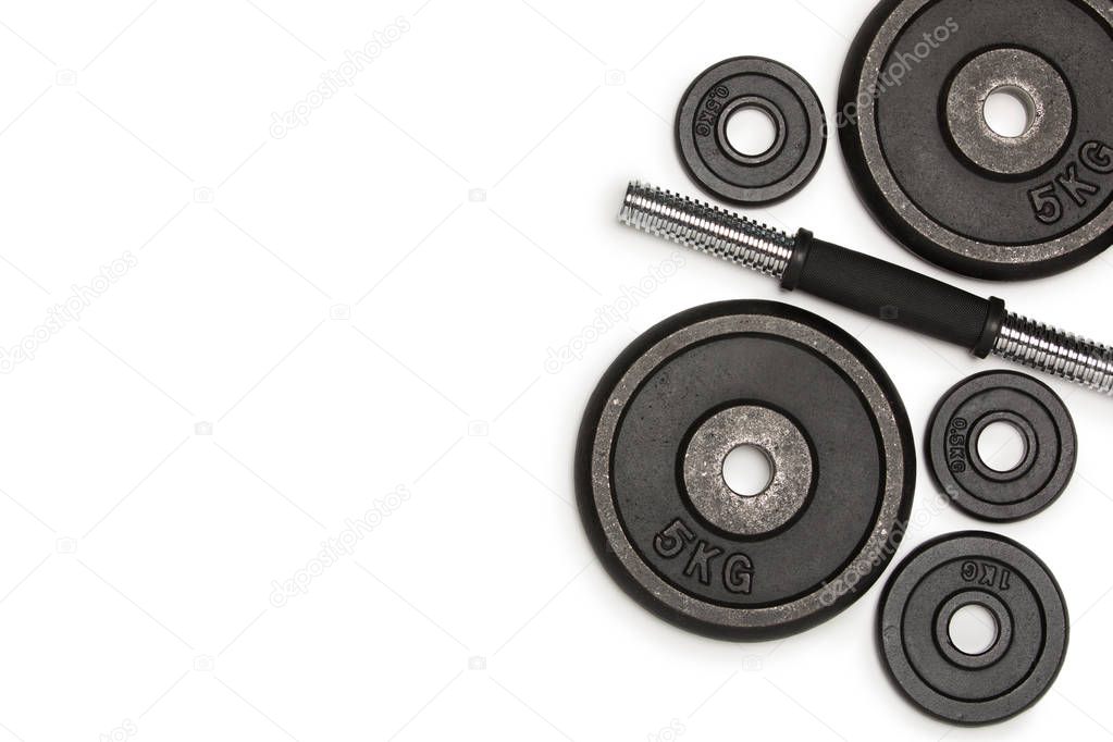 Top view of heavy weight plates with iron bar isolated on white