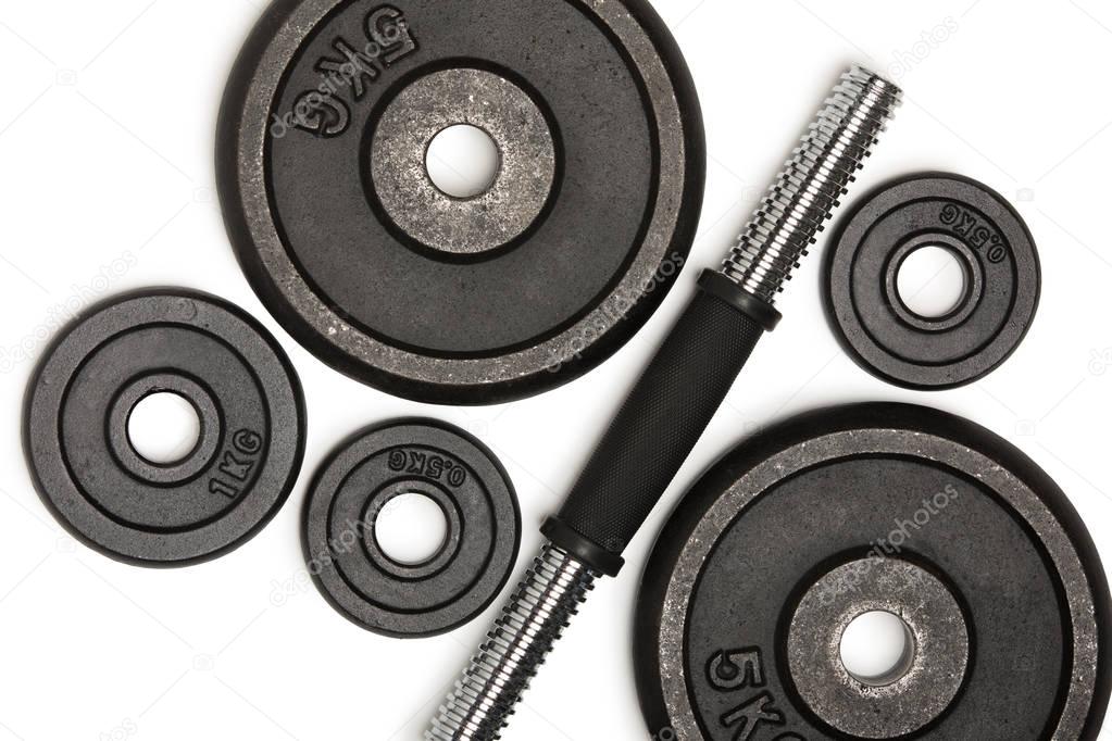 Top view of heavy weight plates with iron bar isolated on white