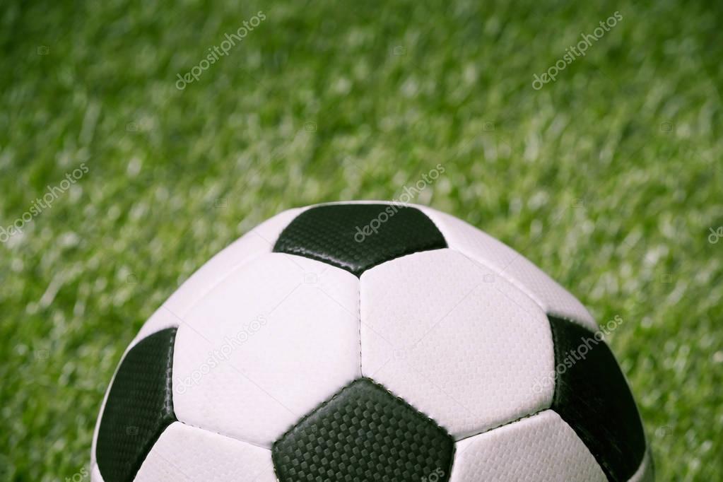 soccer ball on green football pitch