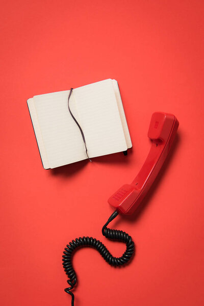 Telephone handset and blank notebook