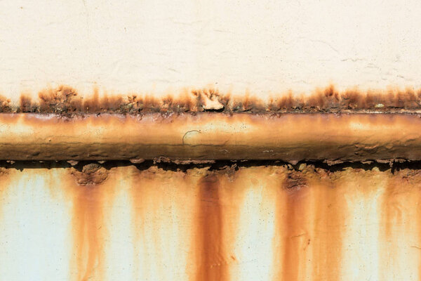 Rusty pipe on wall