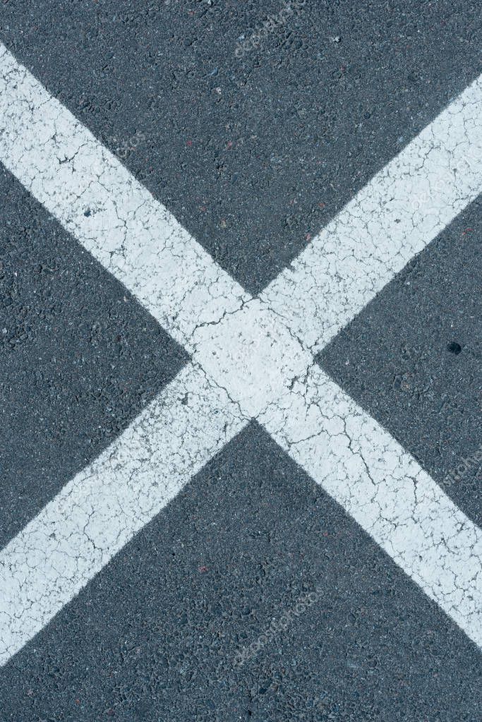 Top view of white parking lines on grey roadway background