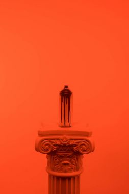 orange toned picture of aerosol paint in can on column clipart