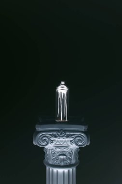 close up view of spray paint in can standing on column isolated on black clipart