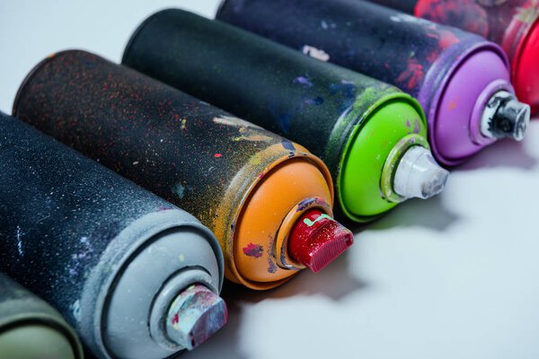 close up view of arranged colorful spray paint in cans