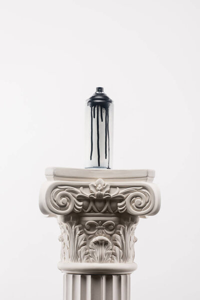 close up view of spray paint in can standing on column isolated on white