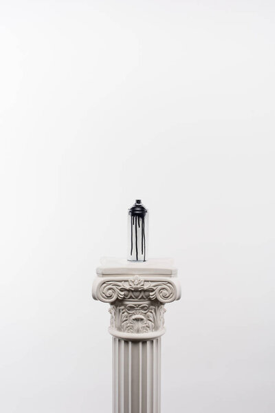 close up view of spray paint in can standing on column isolated on white