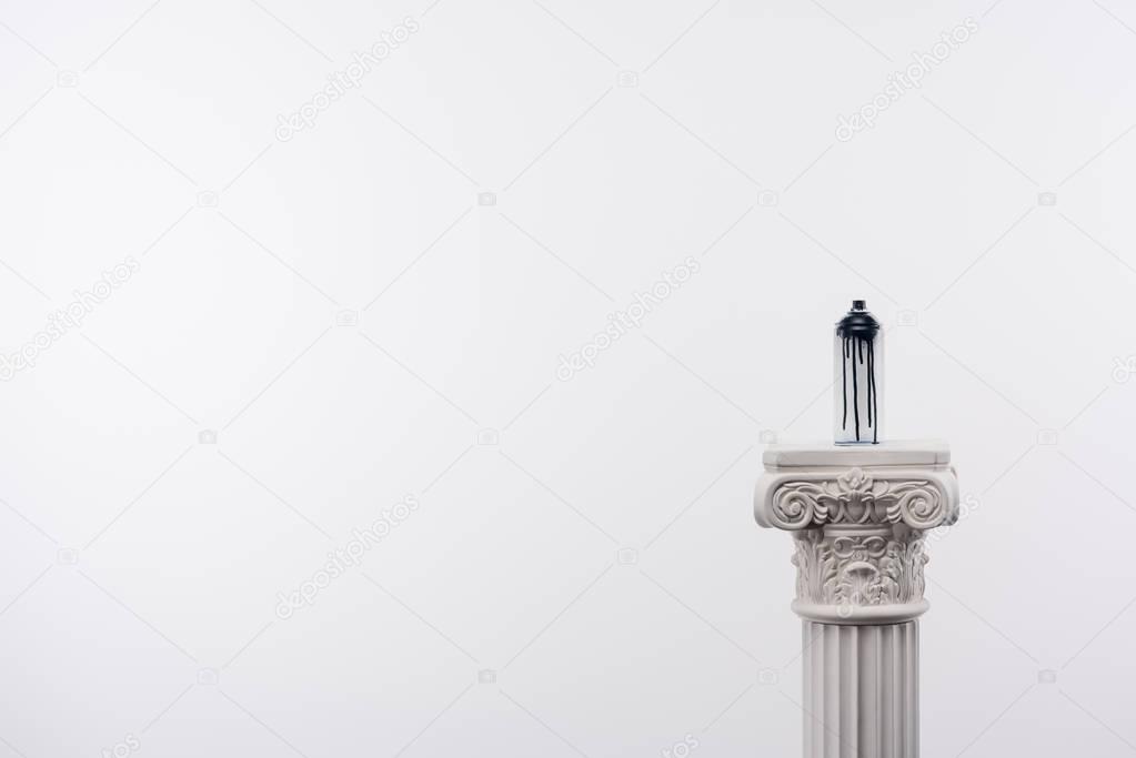 close up view of spray paint in can standing on column isolated on white