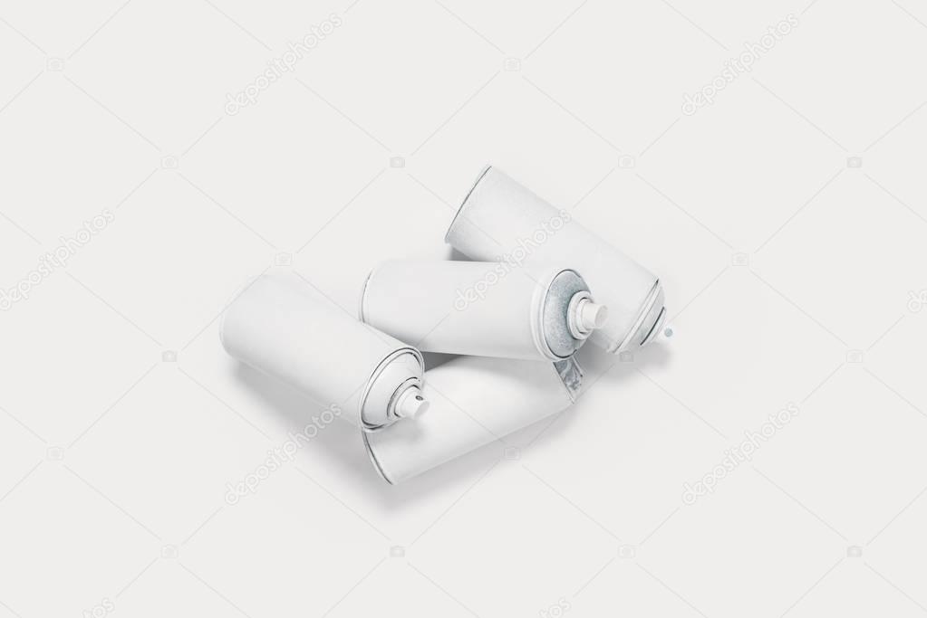 close up view of aerosol paint in cans isolated on white