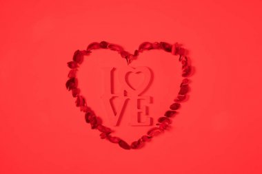 top view of heart from dried fruits with word love isolated on red clipart