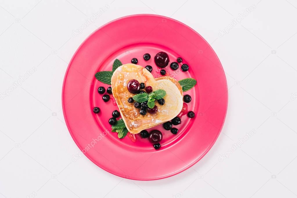 top view of heart shaped pancake with berries and mint isolated on white, valentines day concept