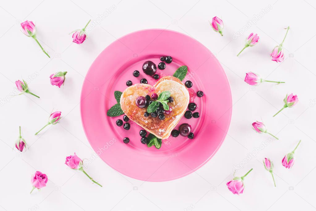 top view of heart shaped pancake and pink roses isolated on white, valentines day concept