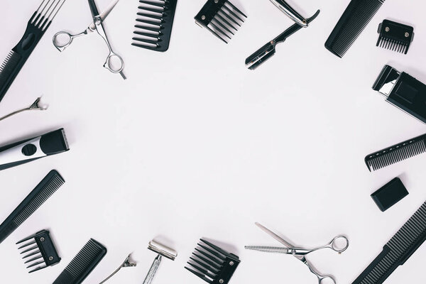 top view of arrangement of various barber tools isolated on grey