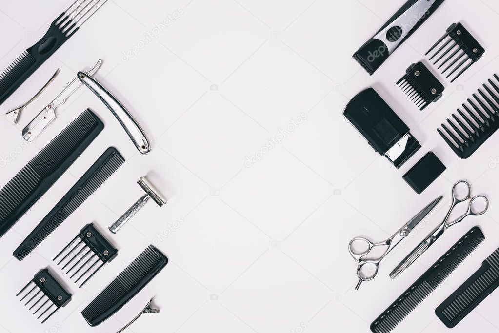 top view of arrangement of various barber tools isolated on grey