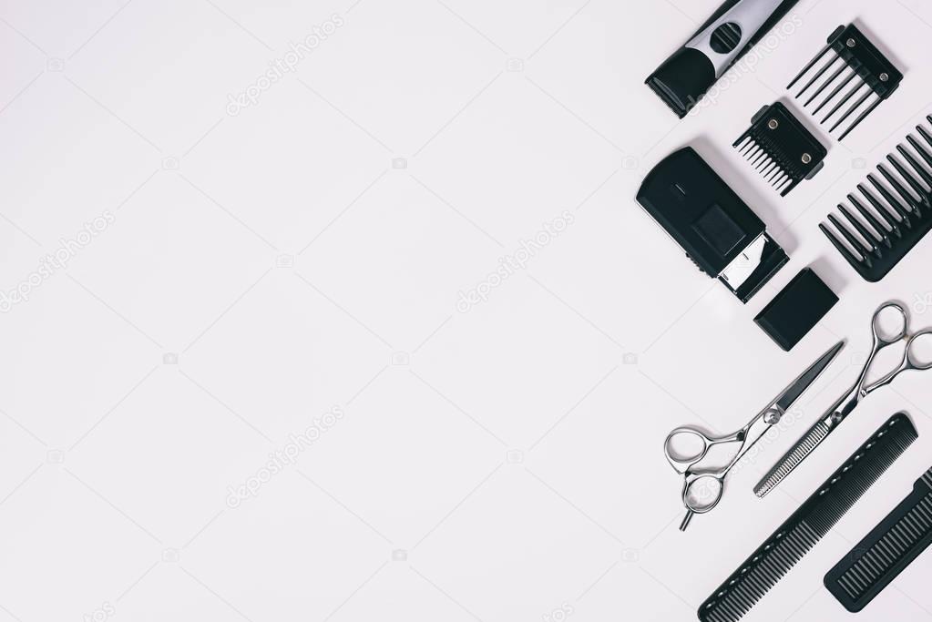 top view of arrangement of various barber tools isolated on grey