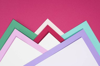 colored different triangles isolated on burgundy clipart