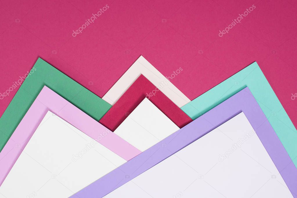 colored different triangles isolated on burgundy