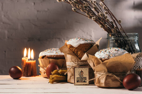 easter bread, orthodox icon and candles on table