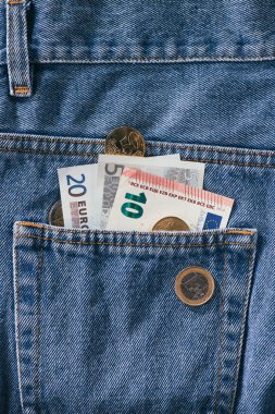 close up view of euro banknotes in jeans pocket clipart