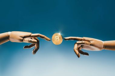Close up view of wooden puppet hands and golden bitcoin on blue backdrop clipart