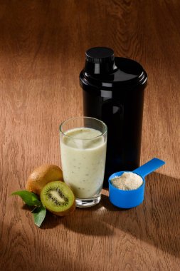 close-up shot of protein shake with kiwi on wooden surface clipart