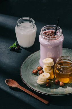 portre resim berry güler yüzlü, reçel, muz dilimleri ve ceviz tabak, kaşık, yoğurt ve kuş üzümü 