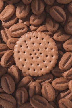 top view of delicious cookies in shape of coffee beans and round cookie clipart