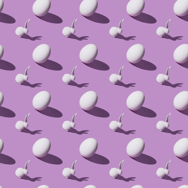 seamless pattern with Easter rabbits and chicken eggs on purple background