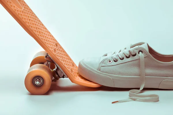Hipster skateboard and sneaker — Stock Photo