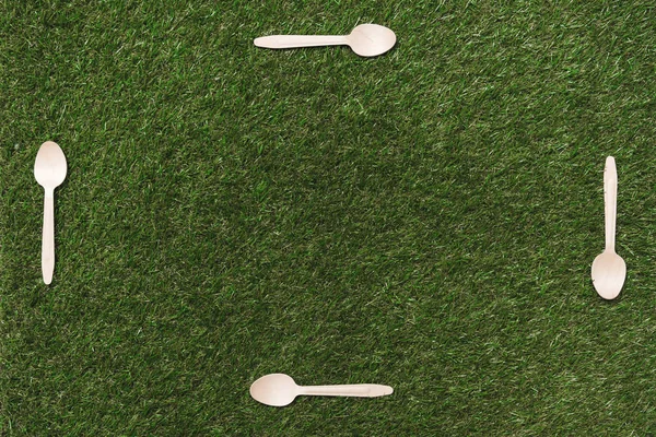 Wooden spoons on grass — Stock Photo