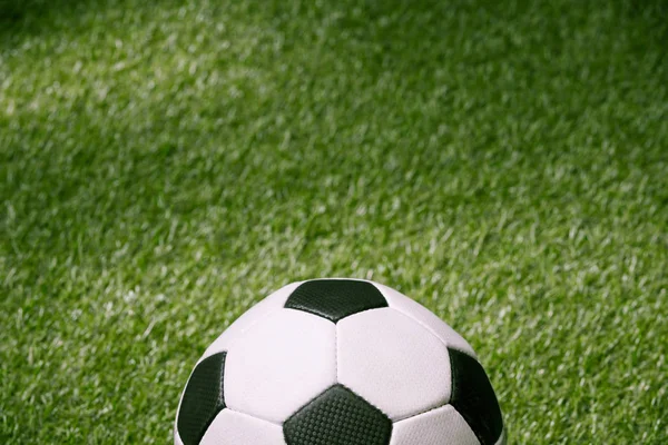 Soccer ball on green football pitch — Stock Photo
