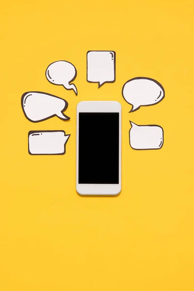 Smartphone y burbujas de voz en blanco - foto de stock