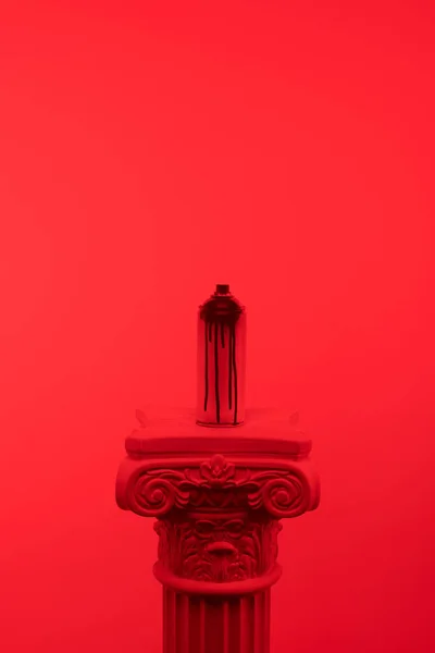 Red toned picture of aerosol paint in can on column — Stock Photo