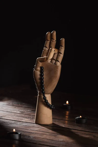 Wooden hand with prithvi mudra gesture and rosary — Stock Photo