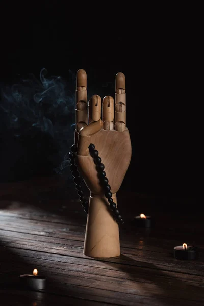 Wooden hand with apan mudra gesture and rosary — Stock Photo