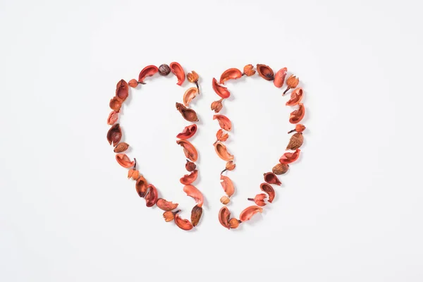 Top view of two halves of heart from dried fruits isolated on white, valentines day concept — Stock Photo