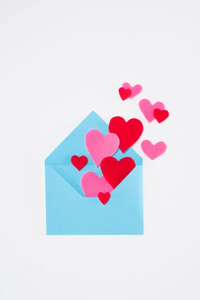 Top view of blue envelope with colored hearts isolated on white, valentines day concept — Stock Photo