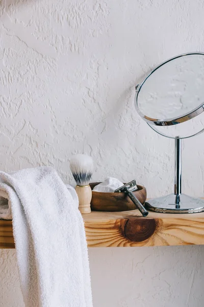 Close up view of arranged barber equipment for shaving on wooden shelf — Stock Photo