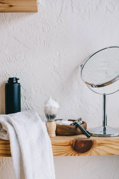 Close up view of arranged barber equipment for shaving on wooden shelf — Stock Photo