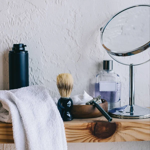 Close up view of arranged barber equipment for shaving on wooden shelf — Stock Photo