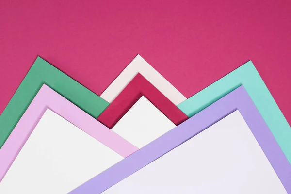 Colored different triangles isolated on burgundy — Stock Photo