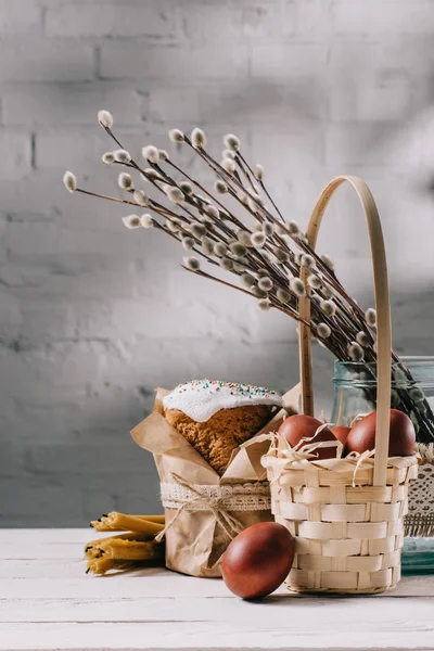 Easter bread, easter chicken eggs and candles on wooden table — Stock Photo