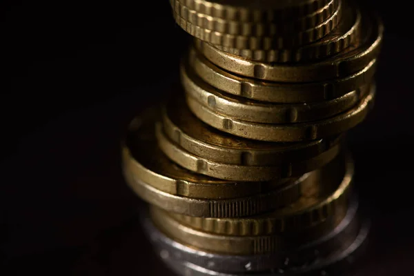 Close up view of pile of coins isolated on black — Stock Photo
