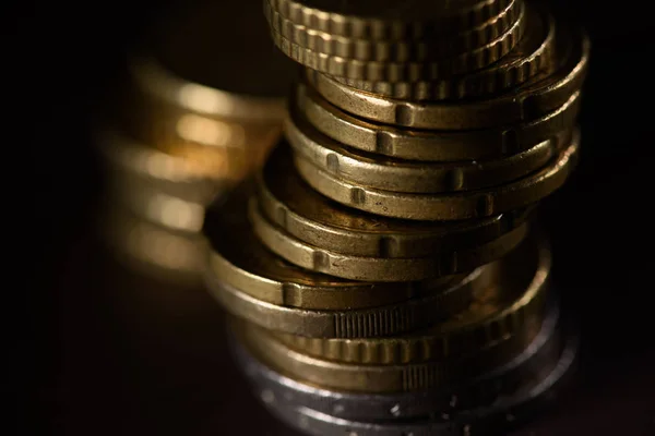 Close up view of pile of coins isolated on black — Stock Photo
