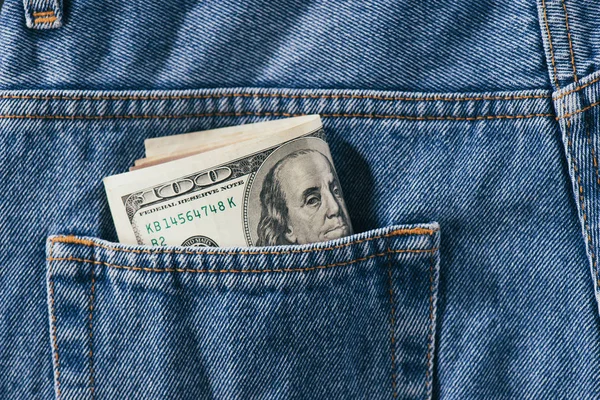 Close up view of dollars banknotes in jeans pocket — Stock Photo