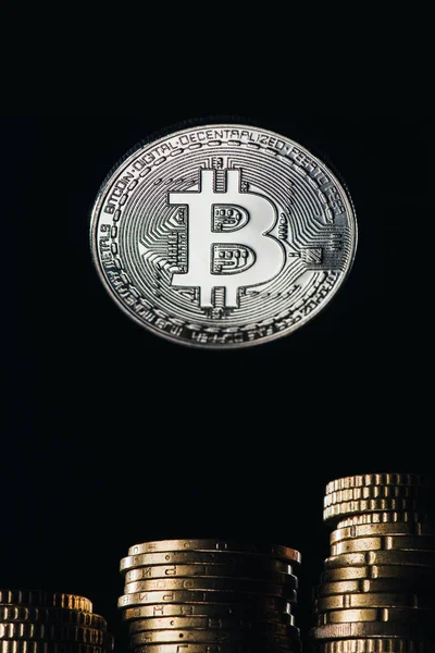 Close up view of silver bitcoin and stacks on cents isolated on black — Stock Photo