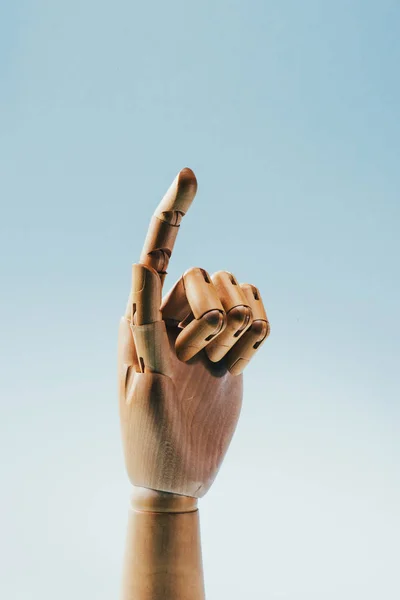 Close up view of wooden puppet hand isolated on blue — Stock Photo