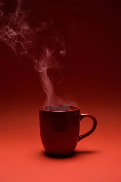 Close up view of red cup of coffee isolated on red — Stock Photo